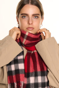 A folded red tartan cashmere scarf.