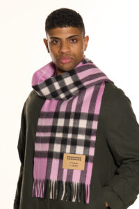 A male model wearing a beige cashmere scarf outdoors.