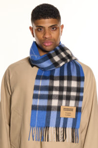 A folded navy tartan cashmere scarf.