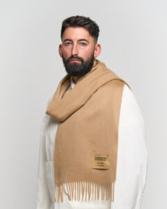 People of different cultures sharing gifts and wearing iconic Scottish cashmere scarves.
