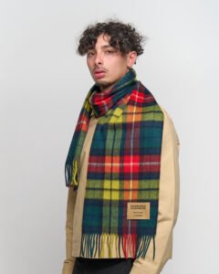 A close-up of an iconic red tartan cashmere scarf, symbolising prosperity and Scottish tradition.